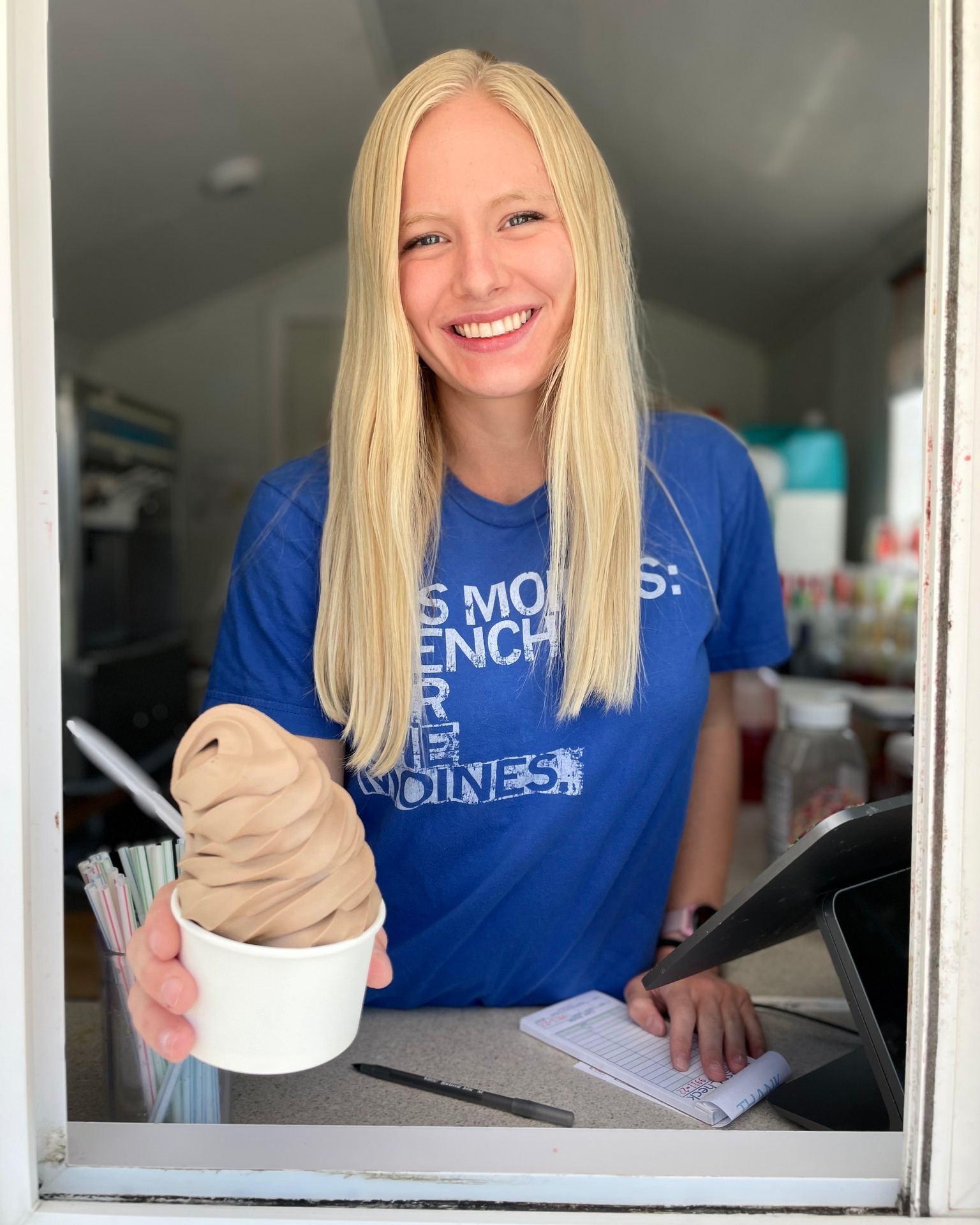 Ashworth Snow staff handing out a soft serve from the stand window
